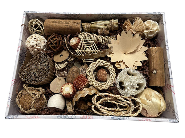Box filled with various natural bird toys including vine, sola, loofah, palm